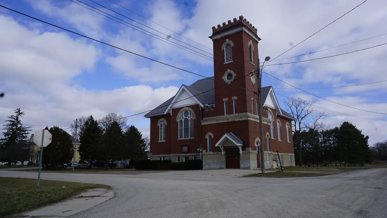 Grace Baptist Church in Kerwood, a red-brick church with a square bell tower, under a blue sky
