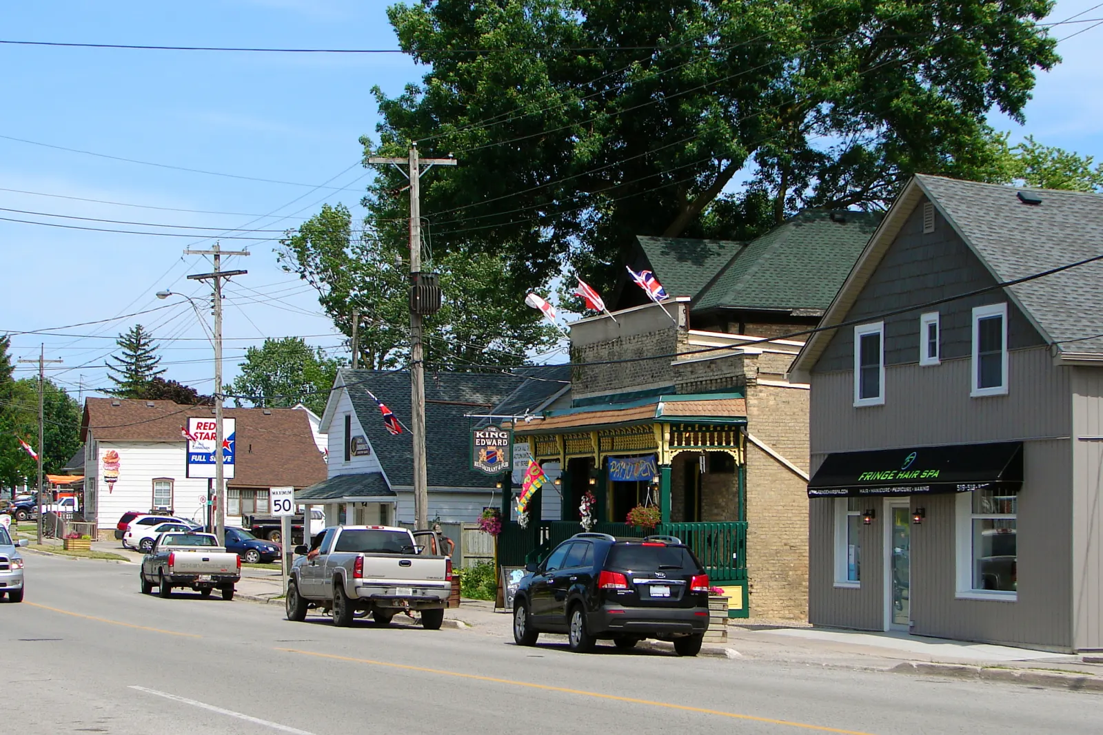 Shops and flags along the main street of Ilderton on a summer day