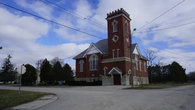 Grace Baptist Church in Kerwood, a red-brick church with a square bell tower, under a blue sky