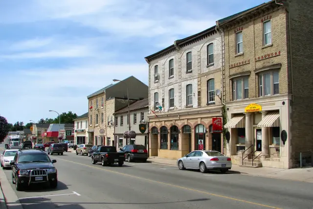 Lucan's Main Street on a sunny day, with brick commercial blocks and shops along the road
