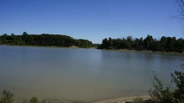 The Parkhill Dam reservoir on a clear day, ringed by trees