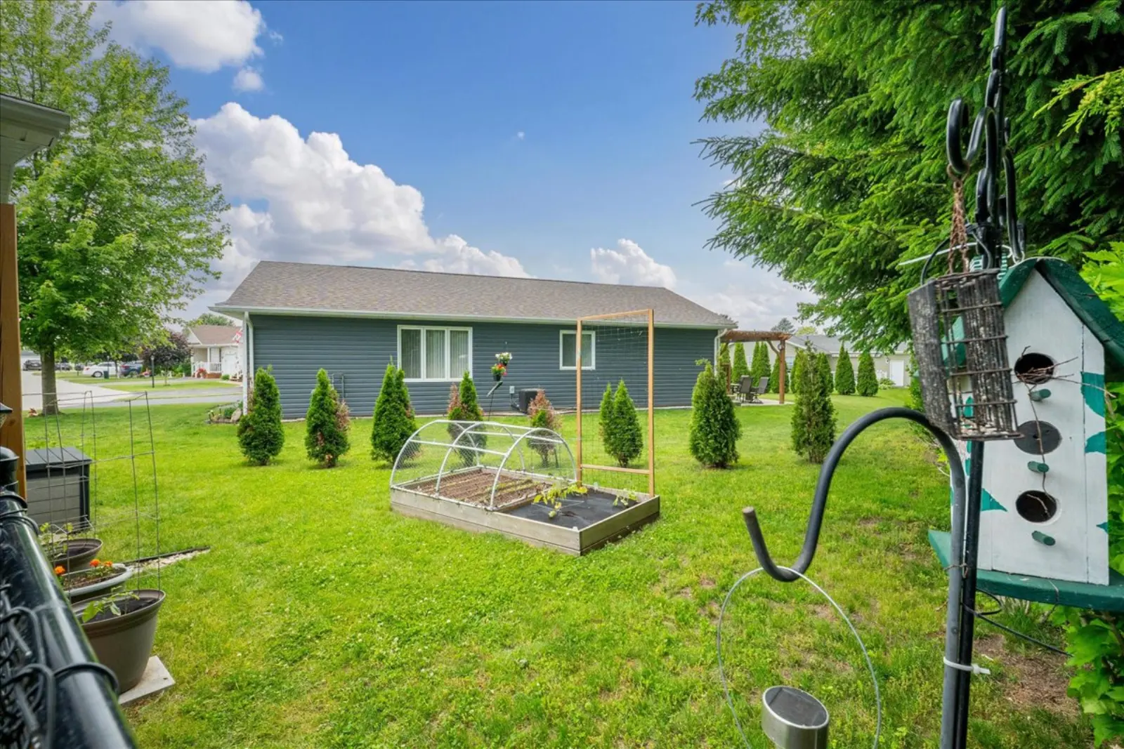 Fenced back yard with a raised garden bed