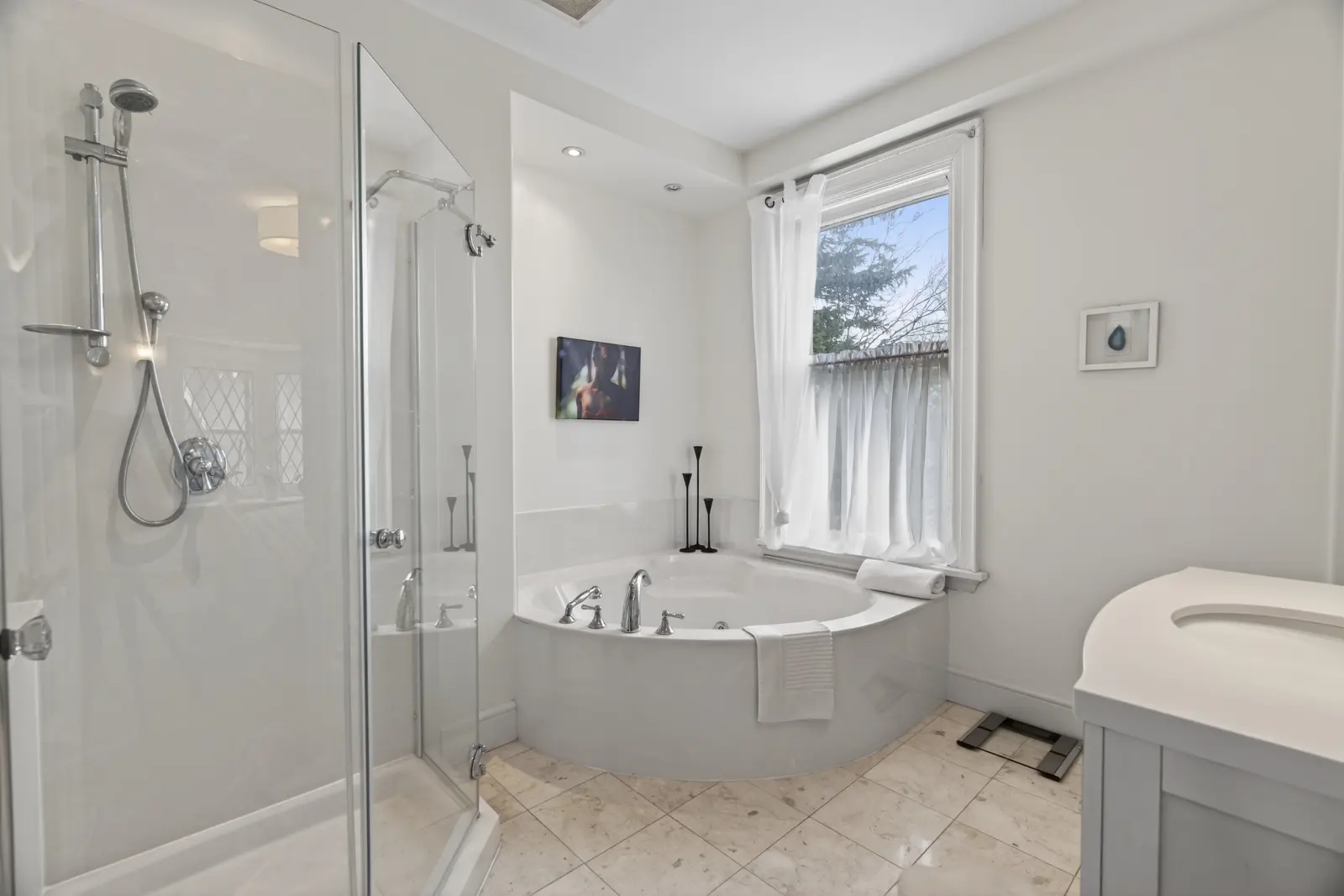 Bathroom with a corner tub and a glass shower