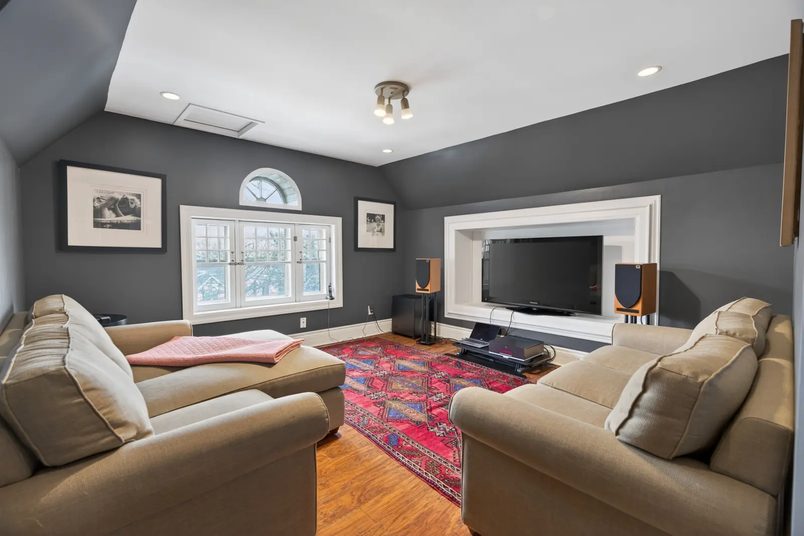 Top-floor room with a TV wall and hardwood floors