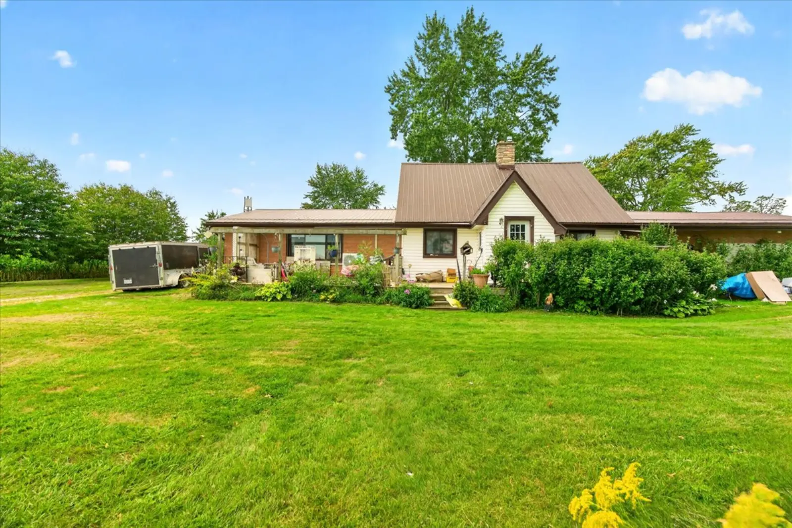 Front of the house behind gardens and a wide lawn