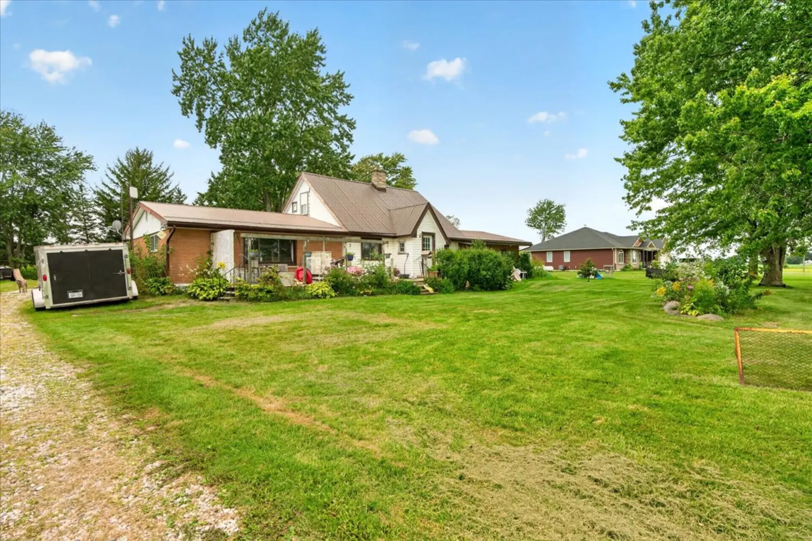 The house and lawn under large trees