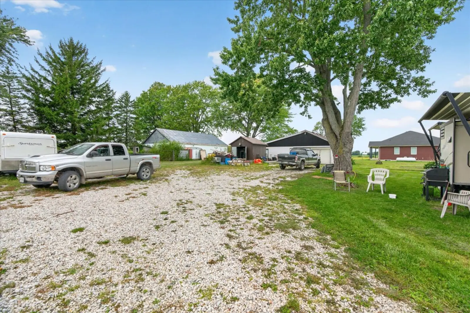 Gravel yard and a large shade tree