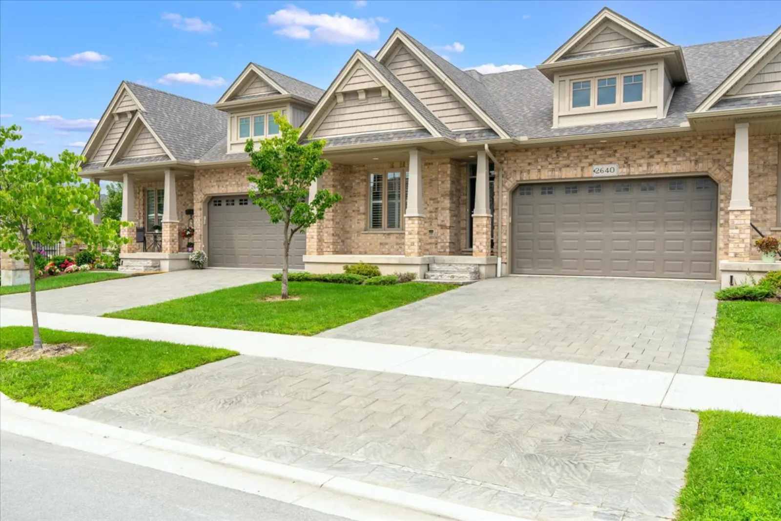 Front of the townhouse with a double garage and a stone-and-brick front
