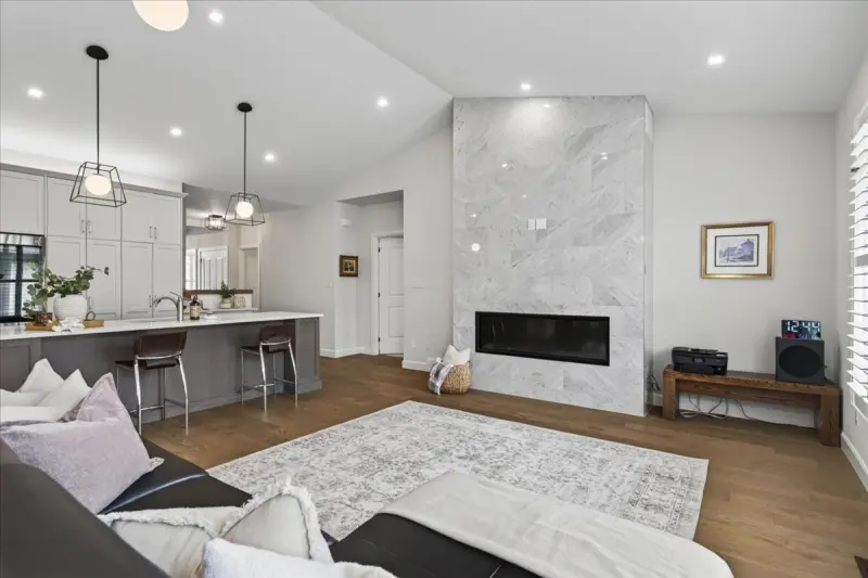 Great room with a vaulted ceiling and a gas fireplace