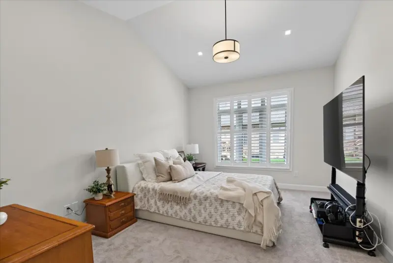 Primary bedroom with shuttered windows