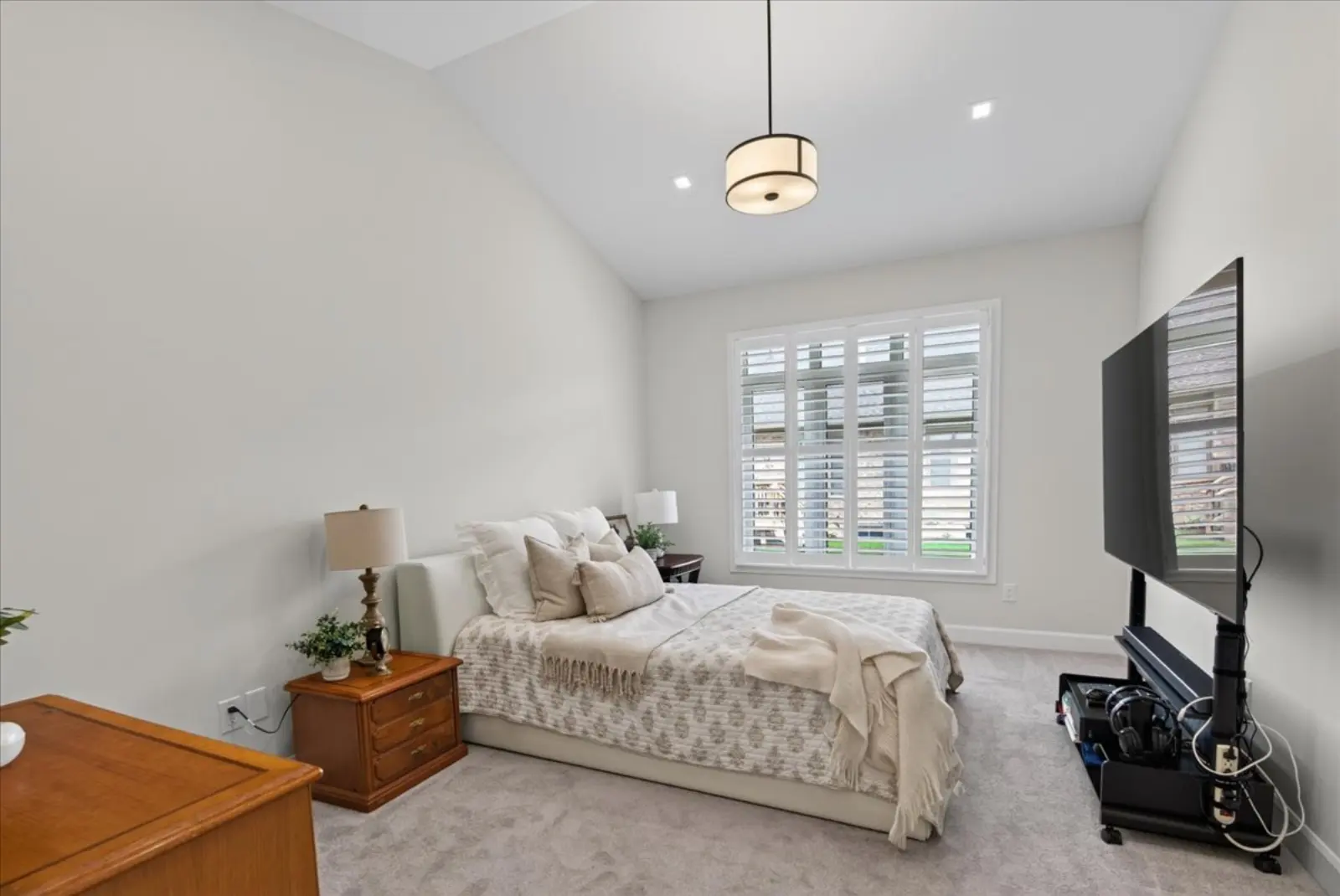 Primary bedroom with shuttered windows