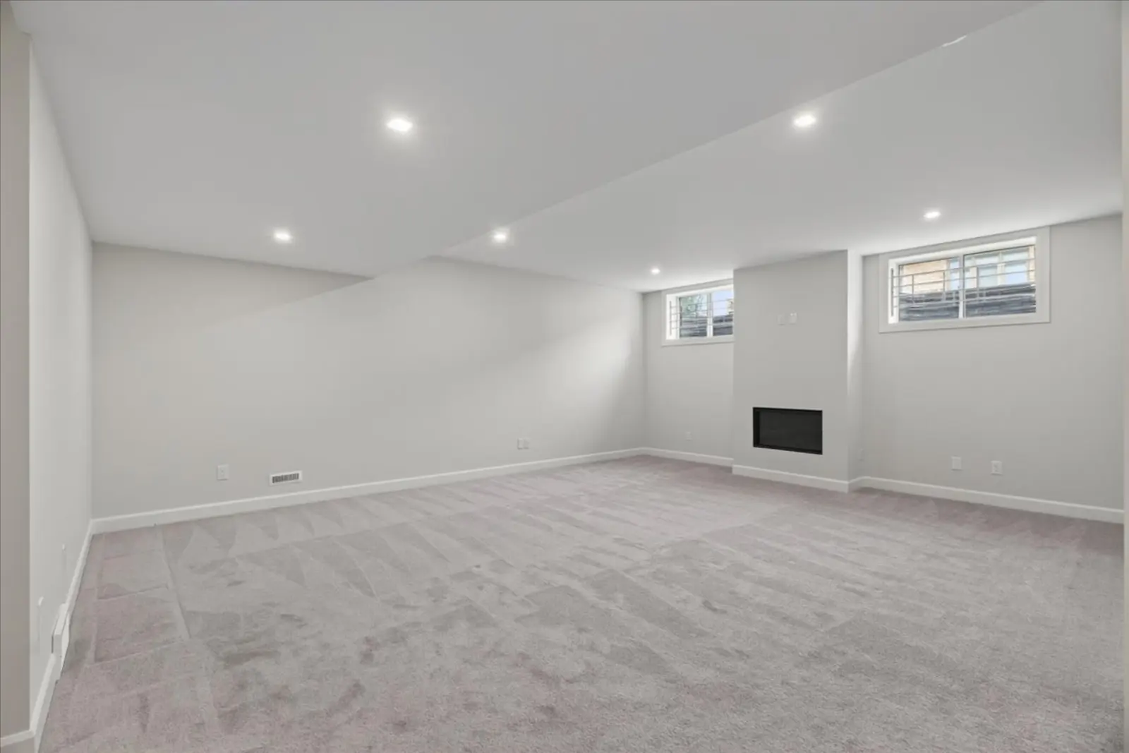 Lower-level family room with a fireplace