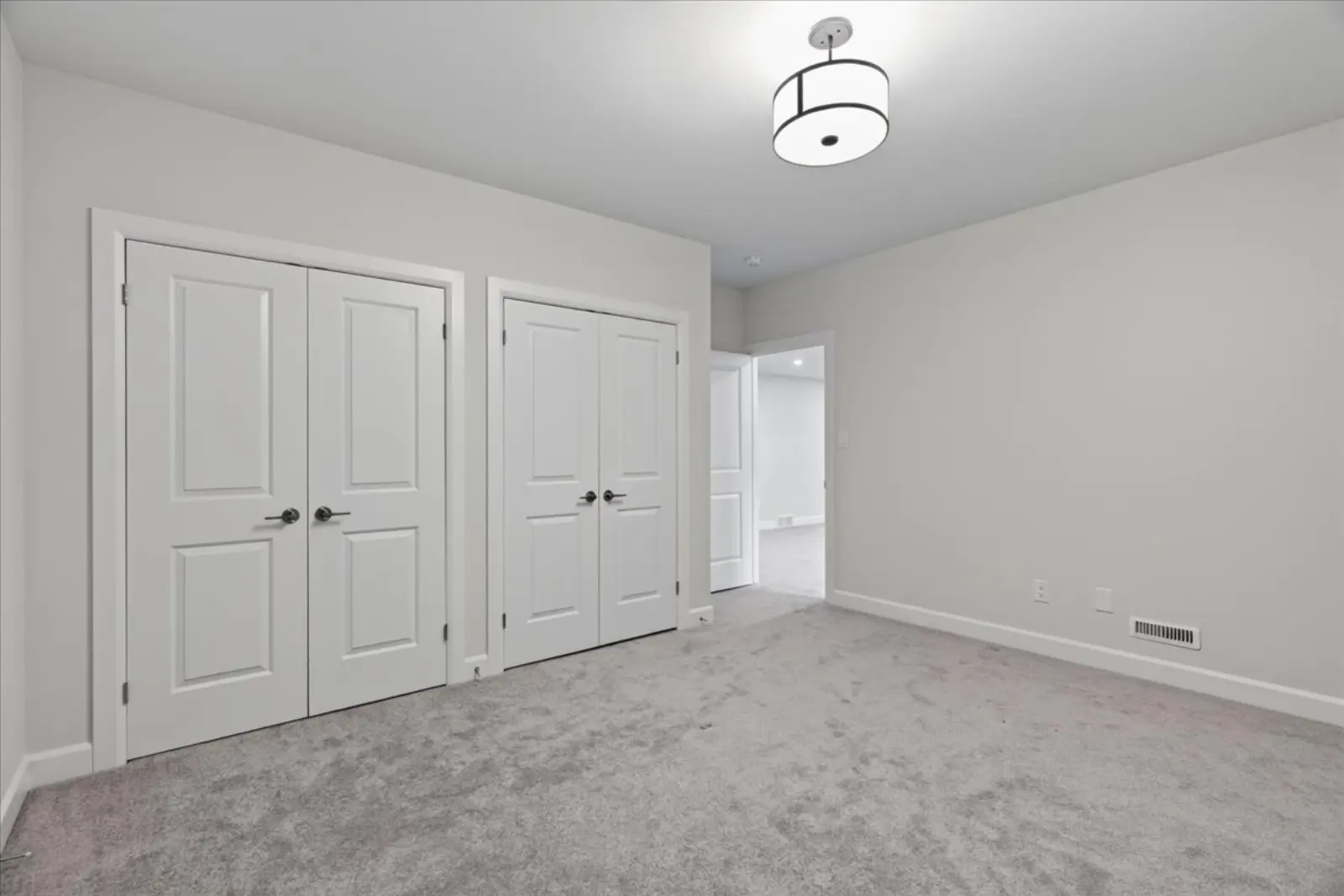Carpeted room with double closets