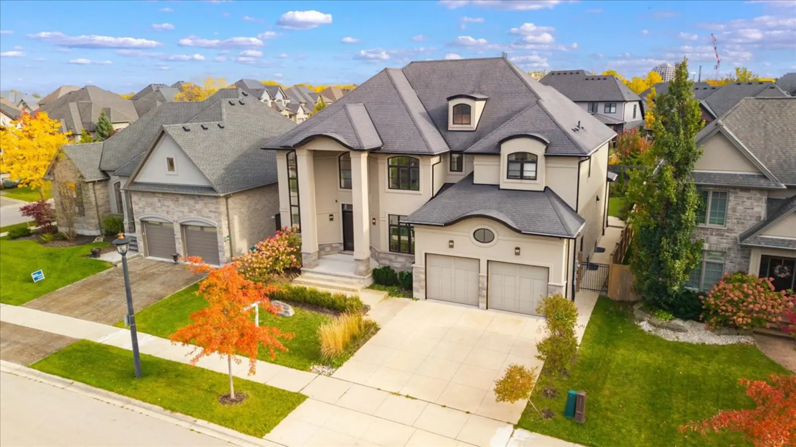 The home from the air, on a street of custom homes