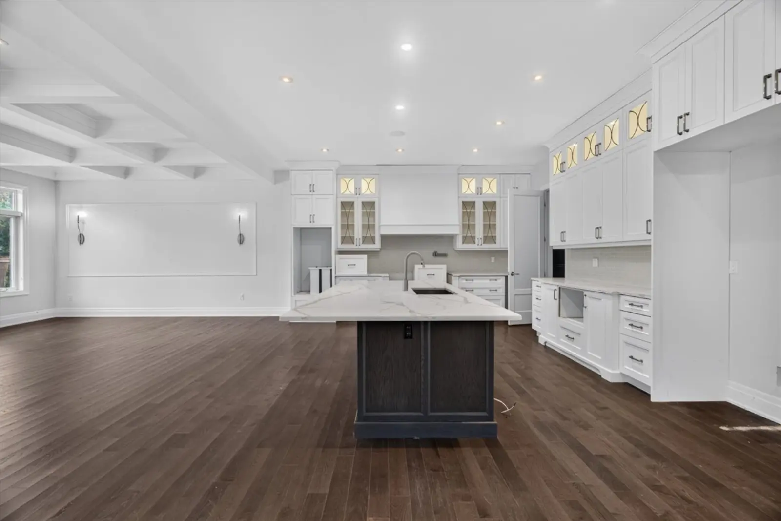 Kitchen with a dark island and white millwork