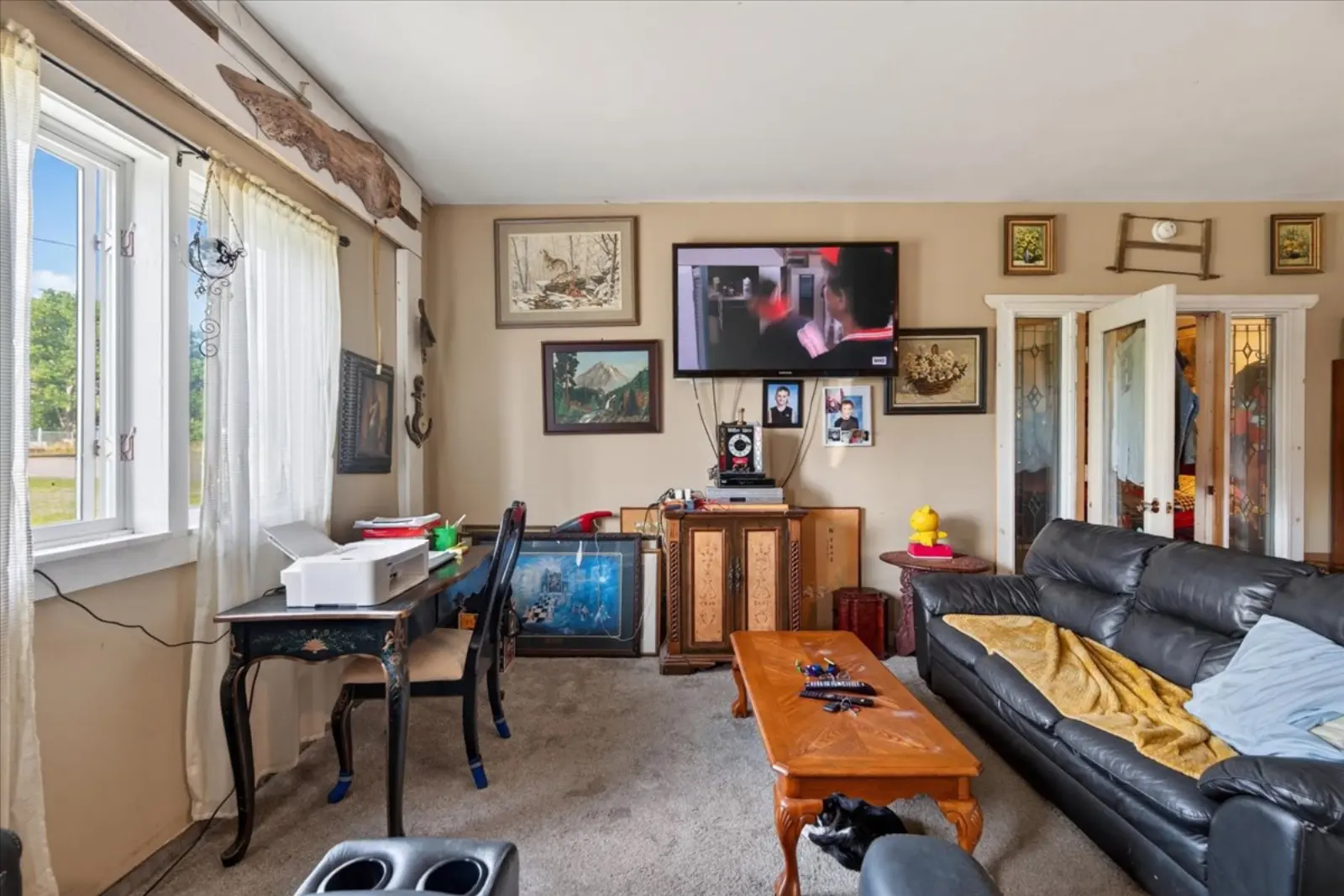 Living room with a sectional and a front window