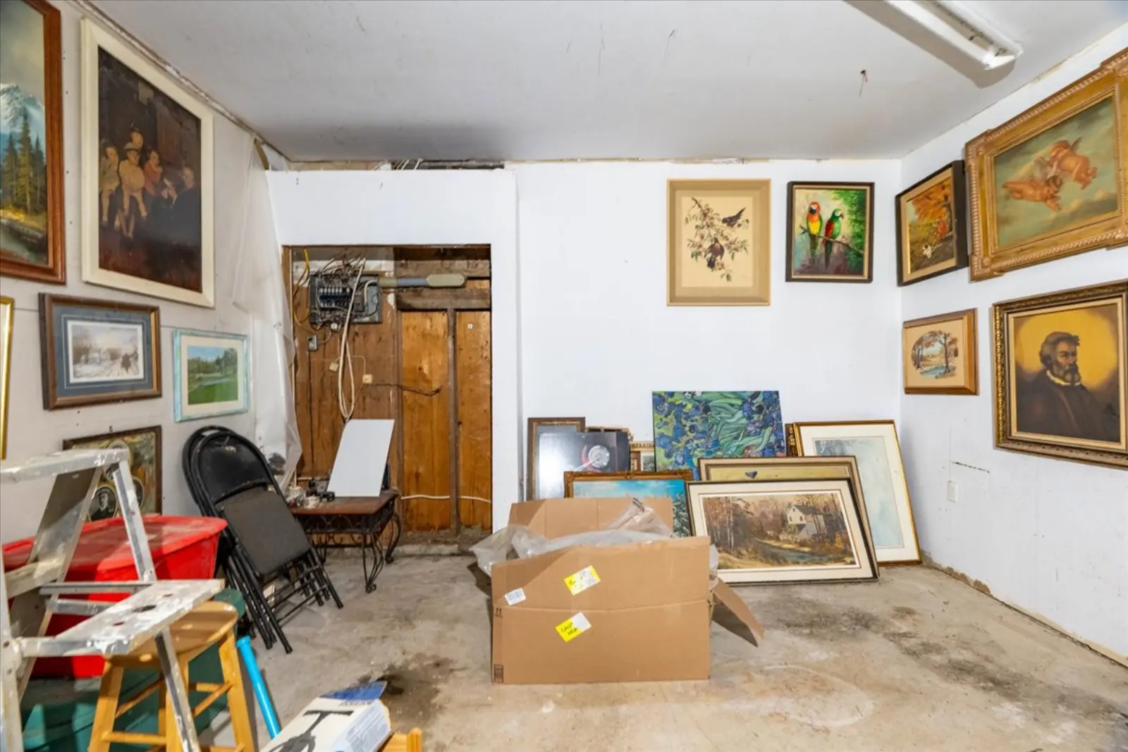 Room with framed pictures on white walls