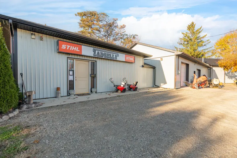 Front of the main building with a storefront and overhead doors