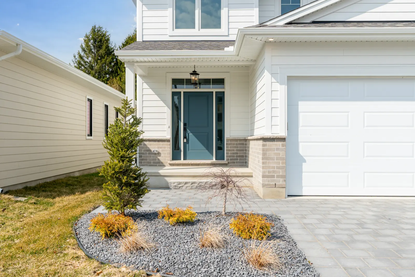 Model home: front entry with stone and a landscaped bed