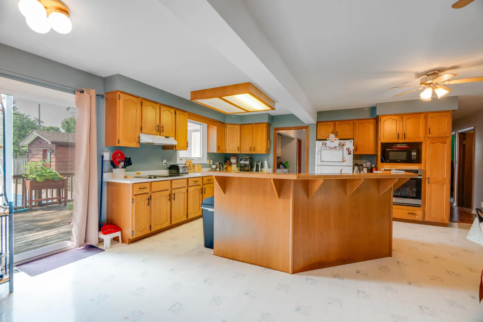 Kitchen with a large centre island and wood cabinets