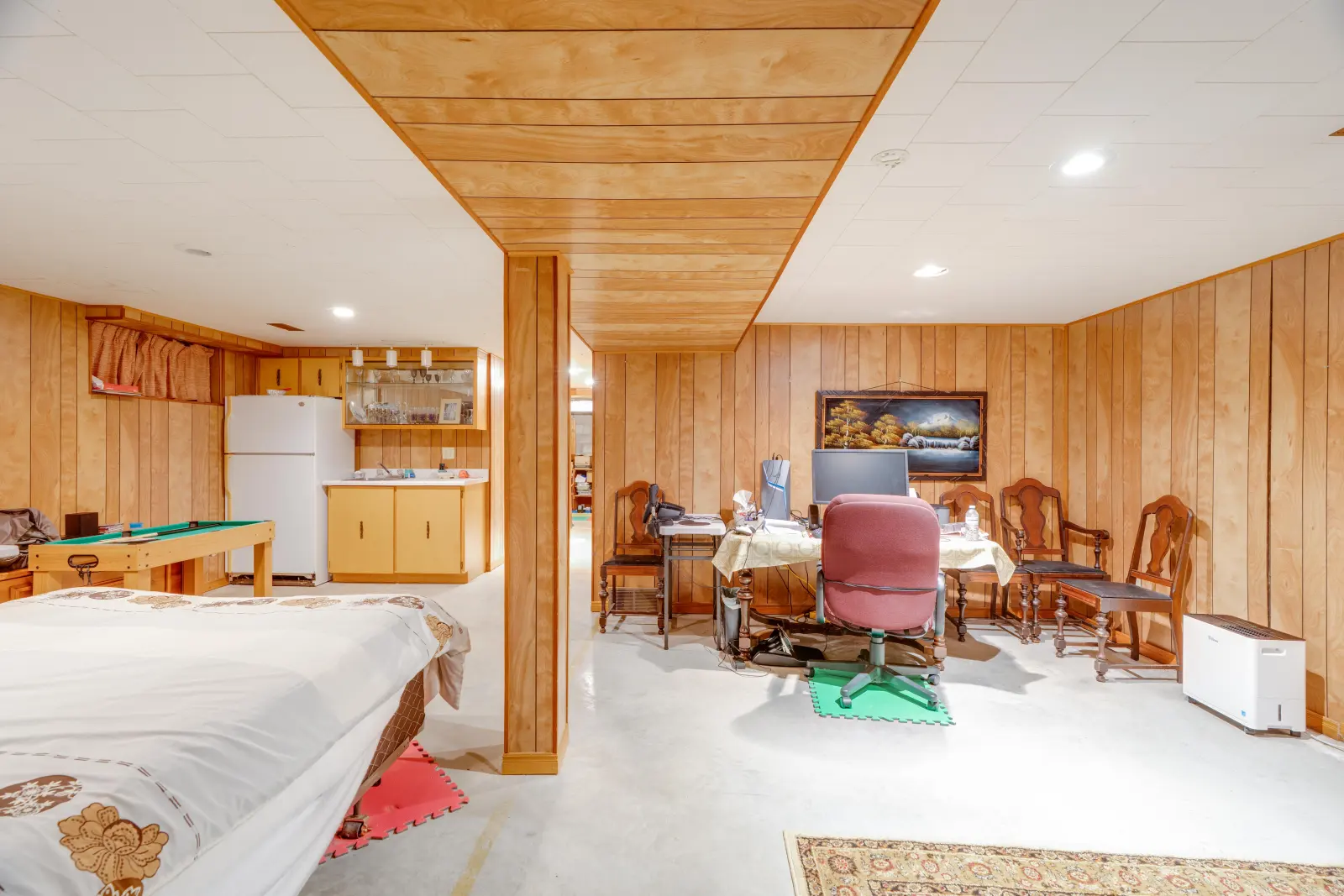 Lower-level recreation room with wood panelling