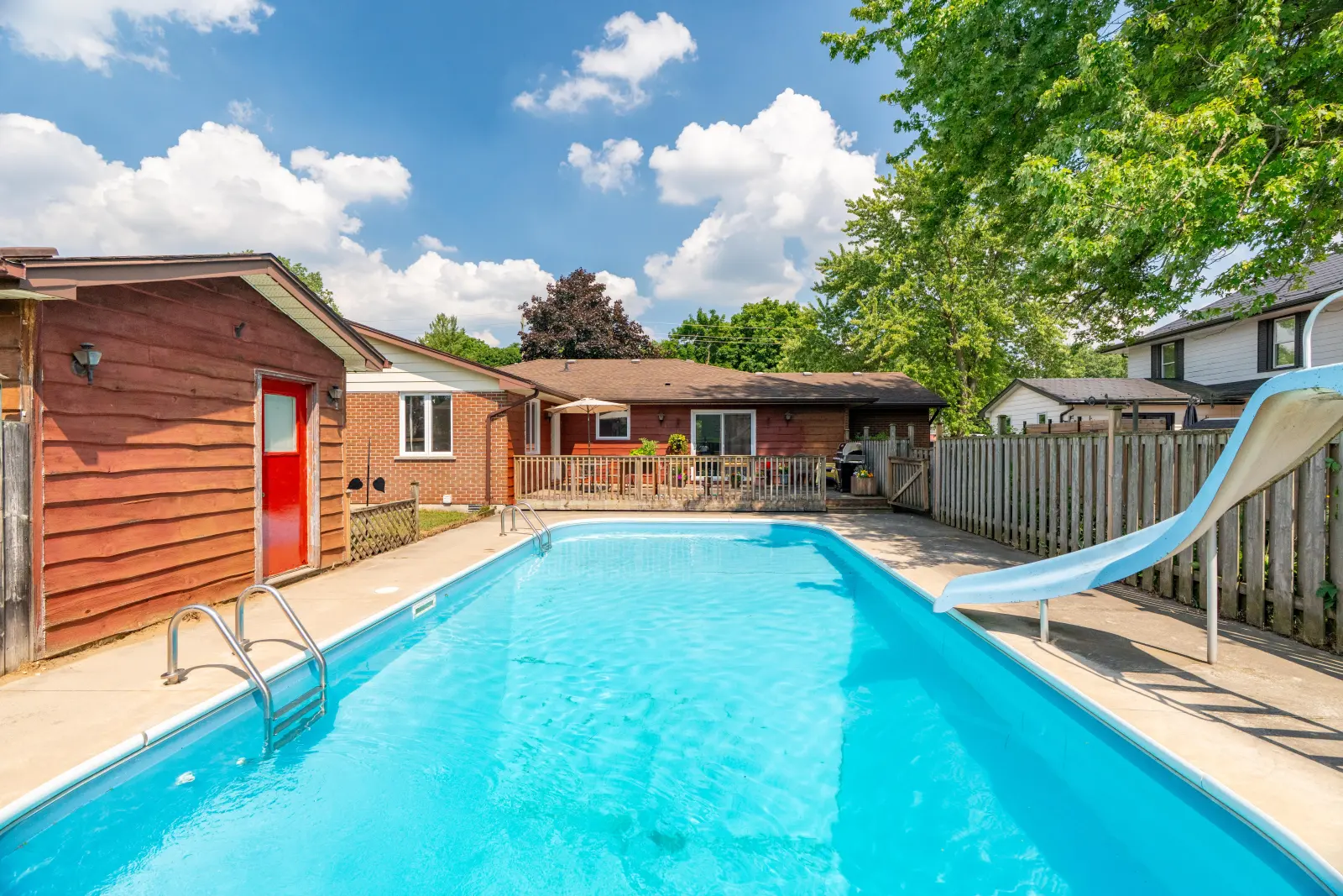 Pool with a slide and the pool shed