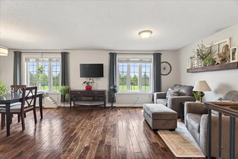 Living room with hardwood floors and large windows