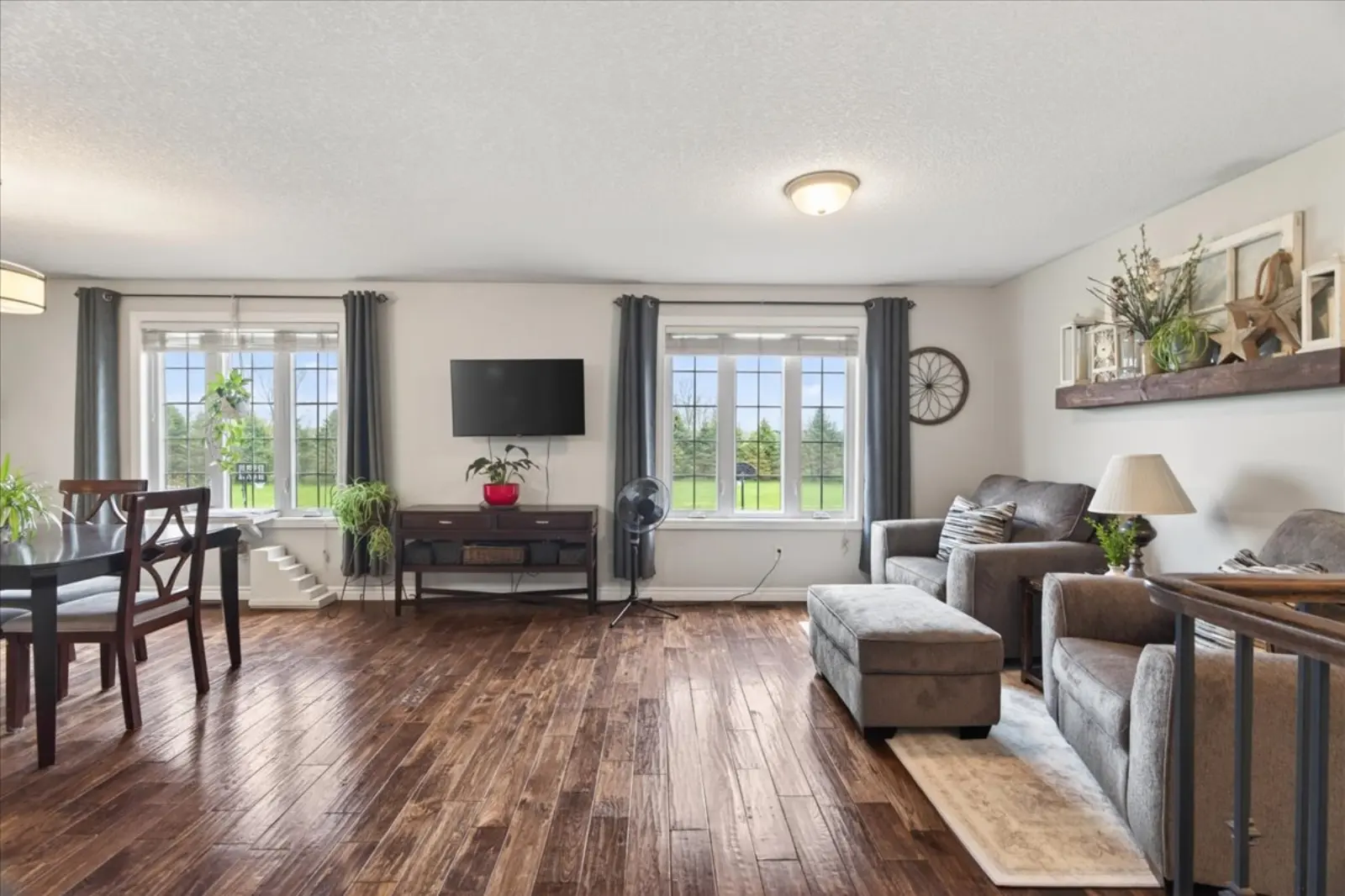 Living room with hardwood floors and large windows