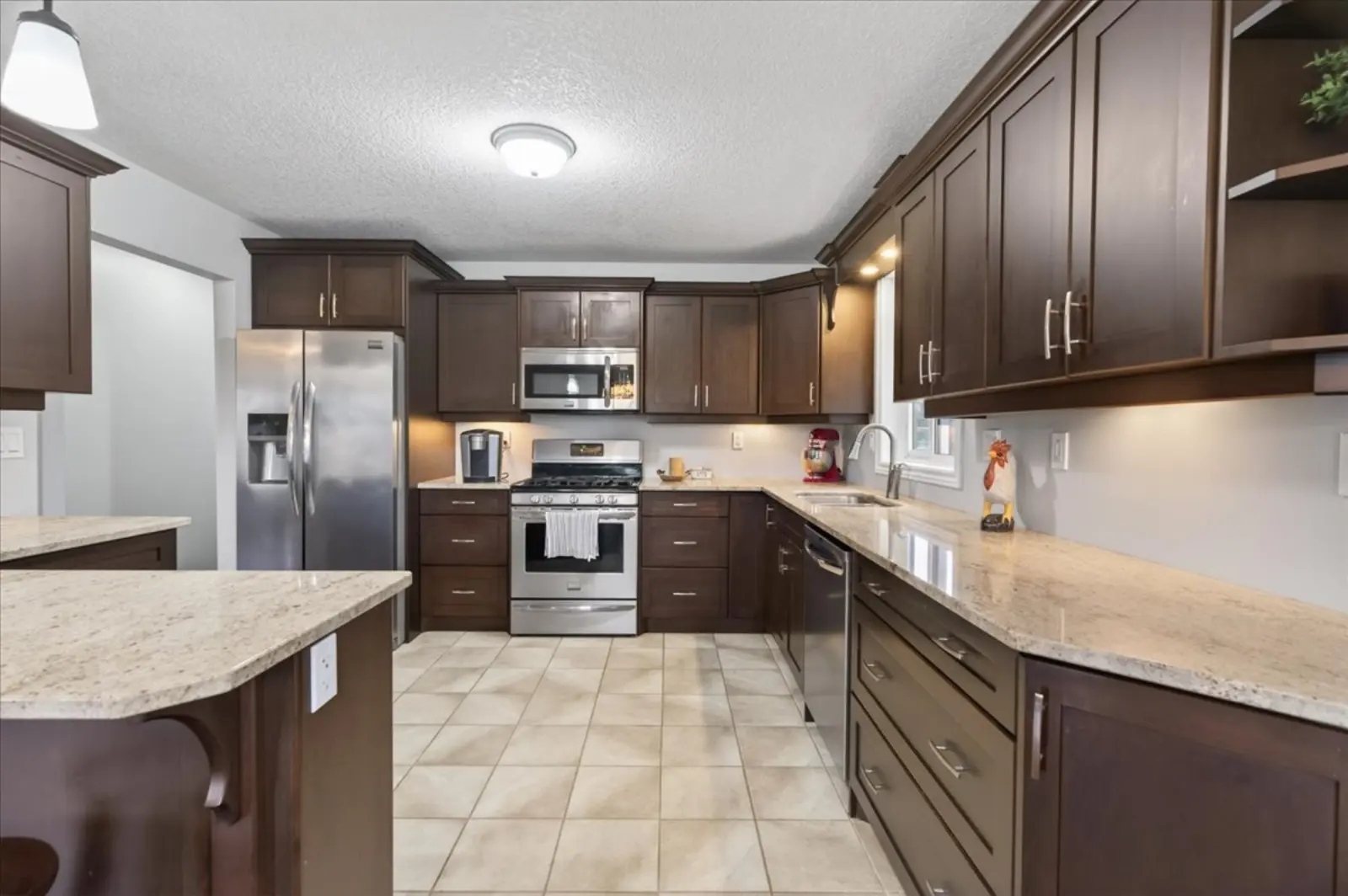 Kitchen with dark cabinets and stainless appliances