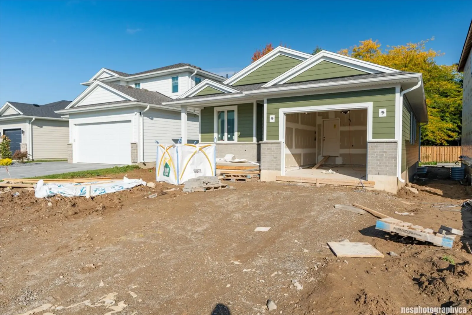 The home from the street with neighbouring new homes
