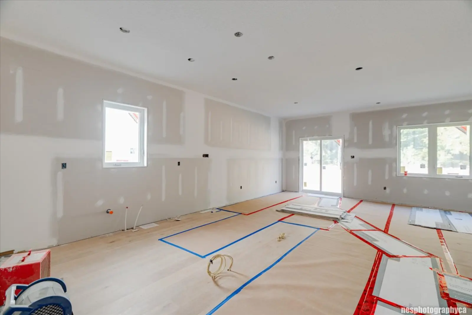 Open main floor at the drywall stage with protected flooring