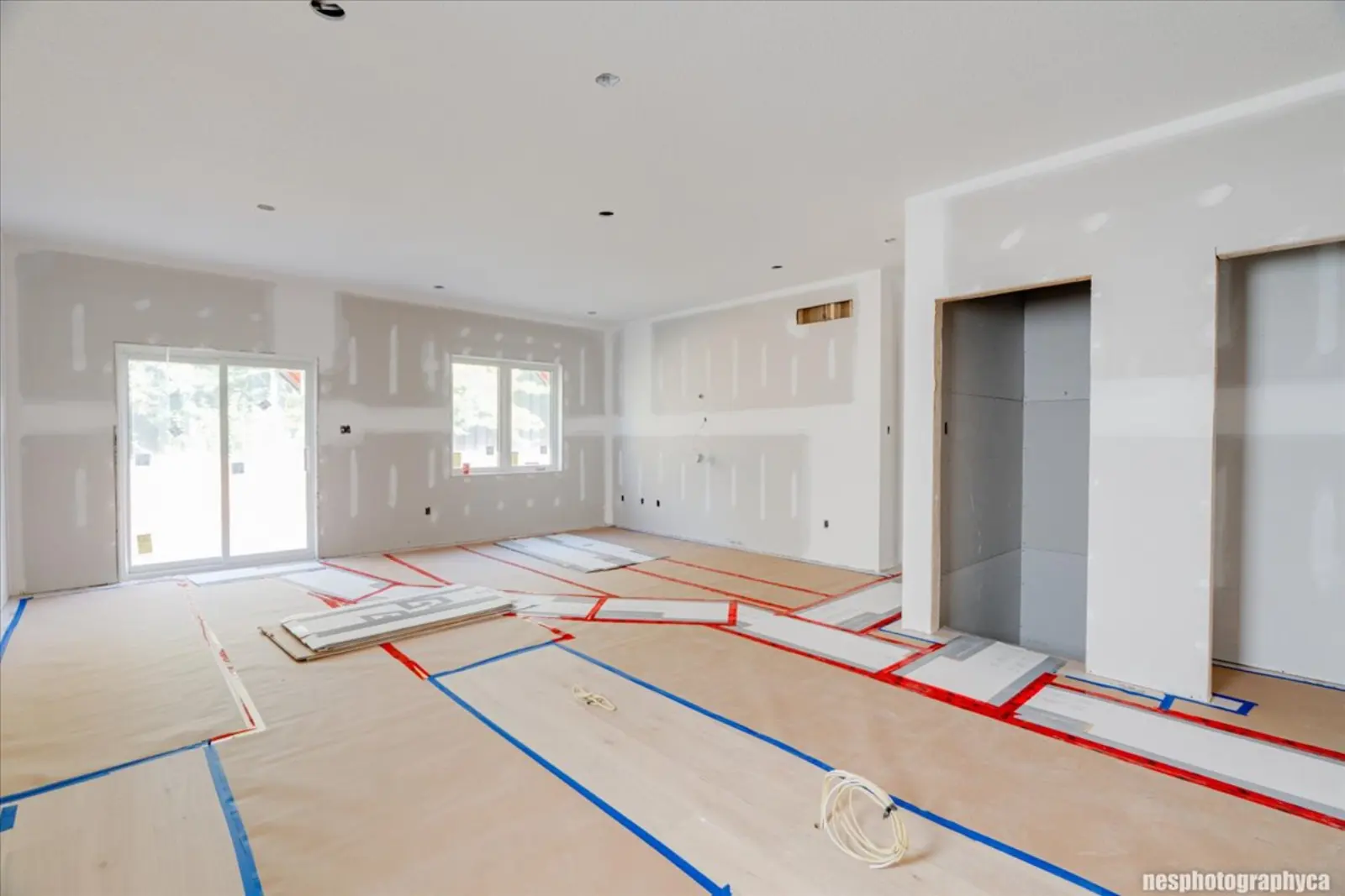 Main living area with patio doors, at the drywall stage