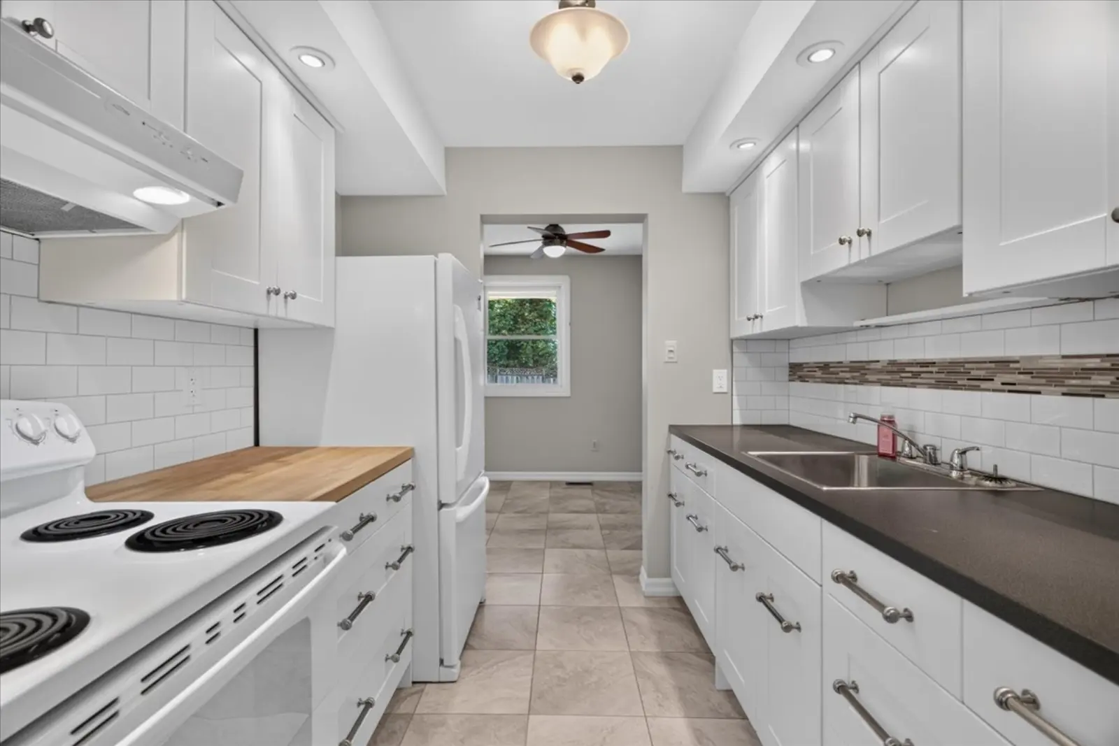 Kitchen with white cabinets and a white stove