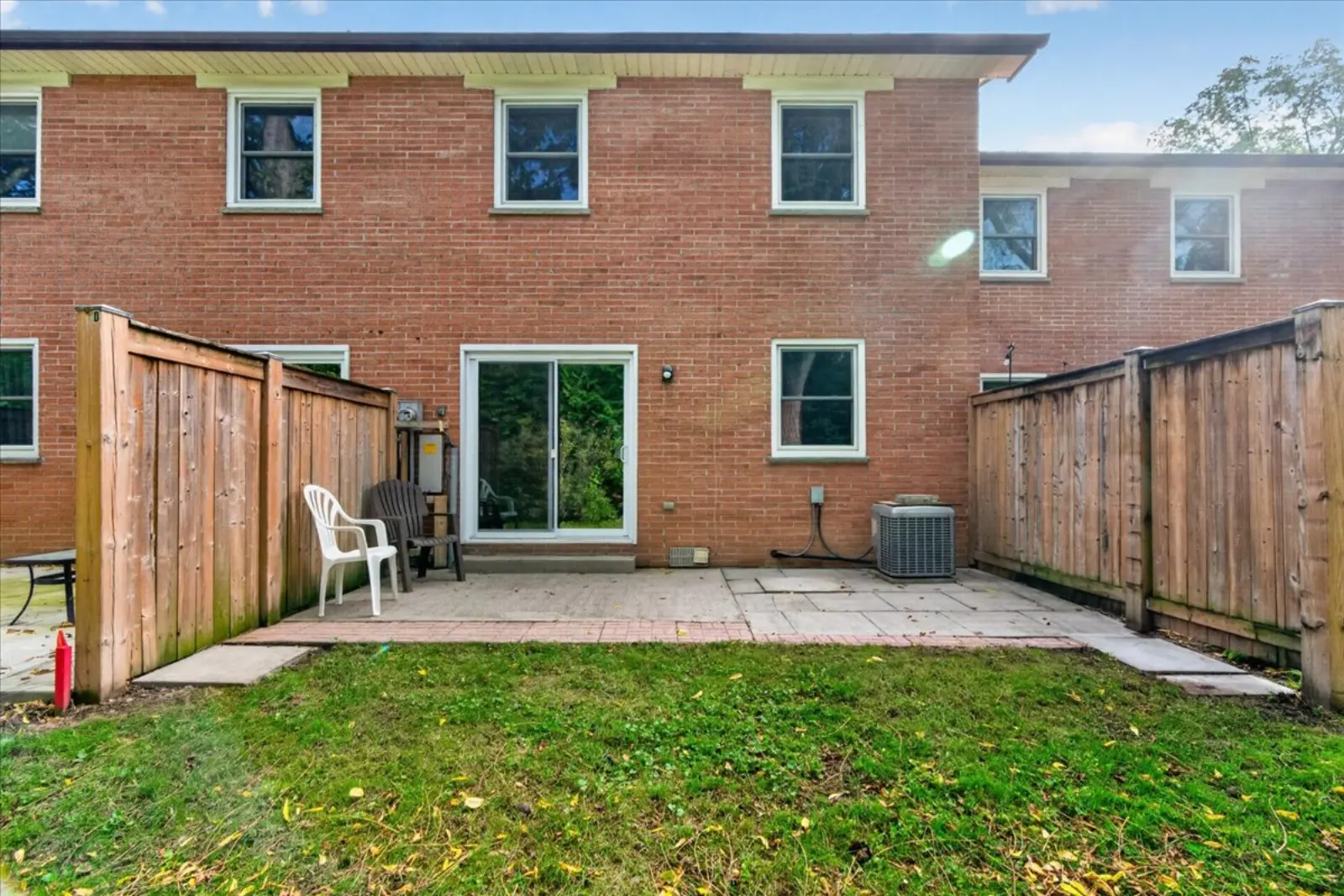 Back of the townhome with a fenced patio