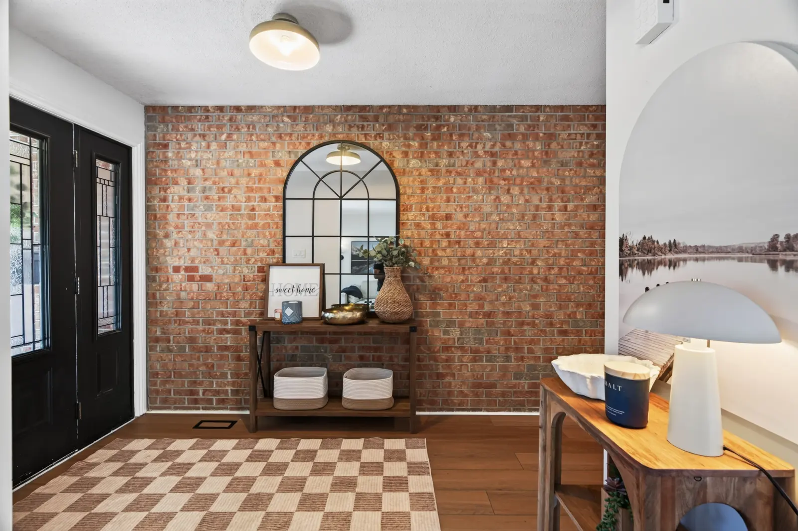 Foyer with an exposed-brick accent wall
