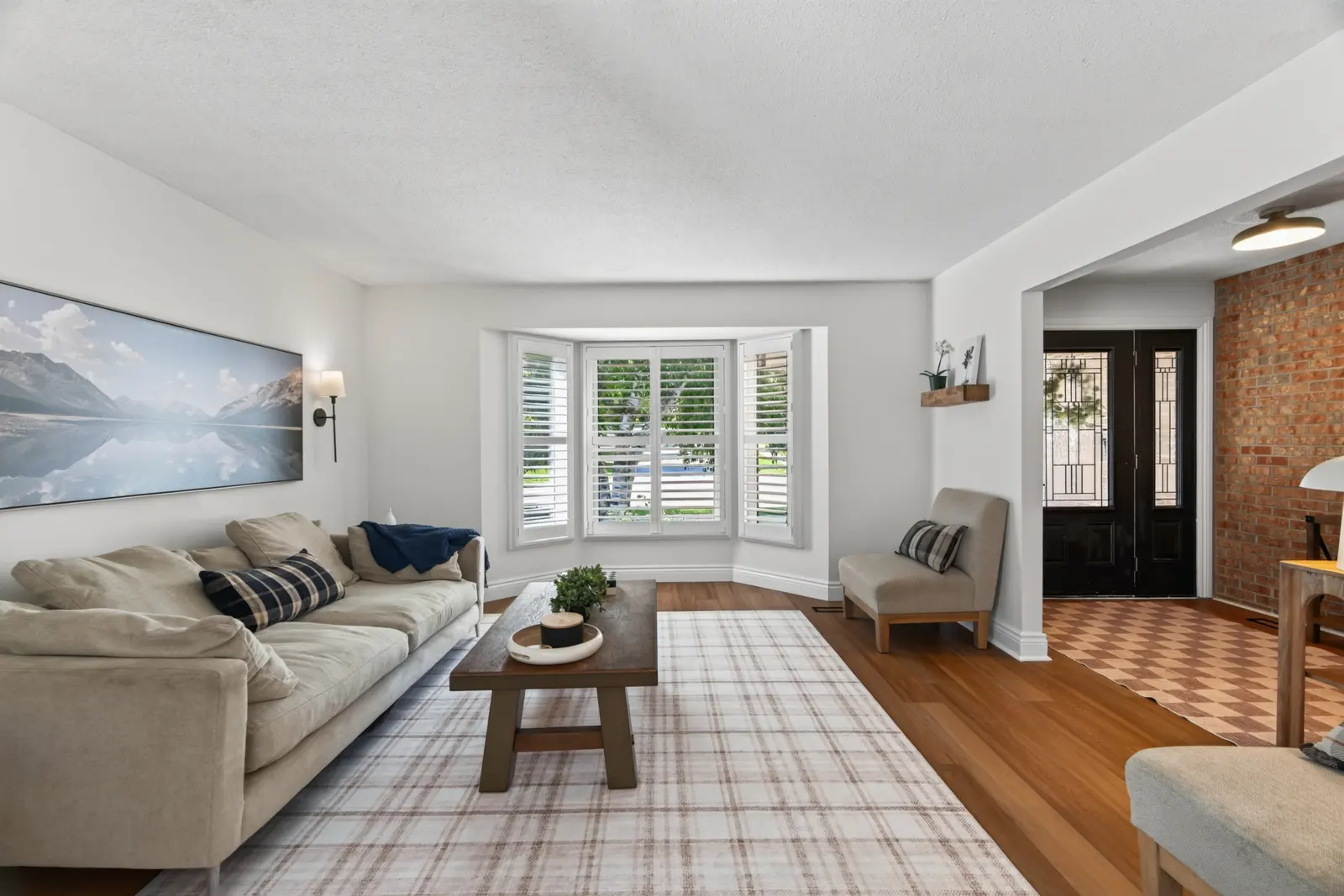 Living room with a bay window and plantation shutters