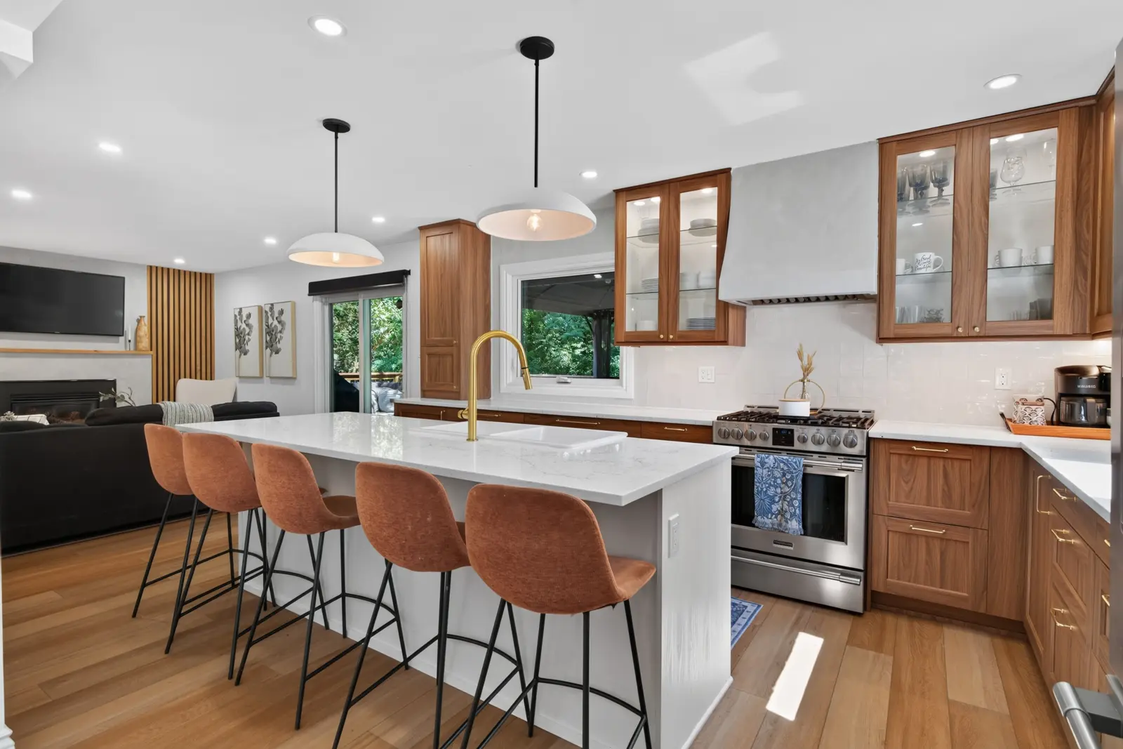Kitchen with a breakfast bar, wood cabinets and a custom hood fan