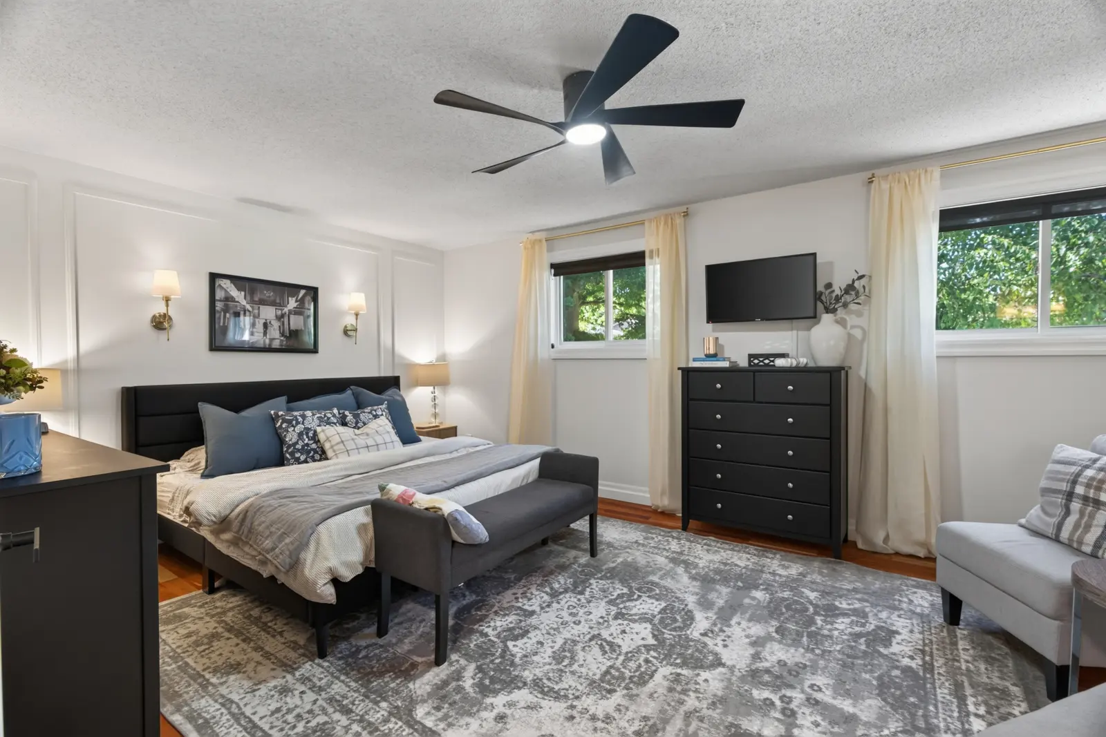 Primary bedroom with a ceiling fan