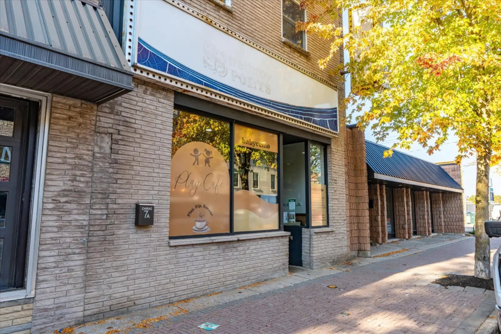 The storefront and brick sidewalk on Front Street West in the fall