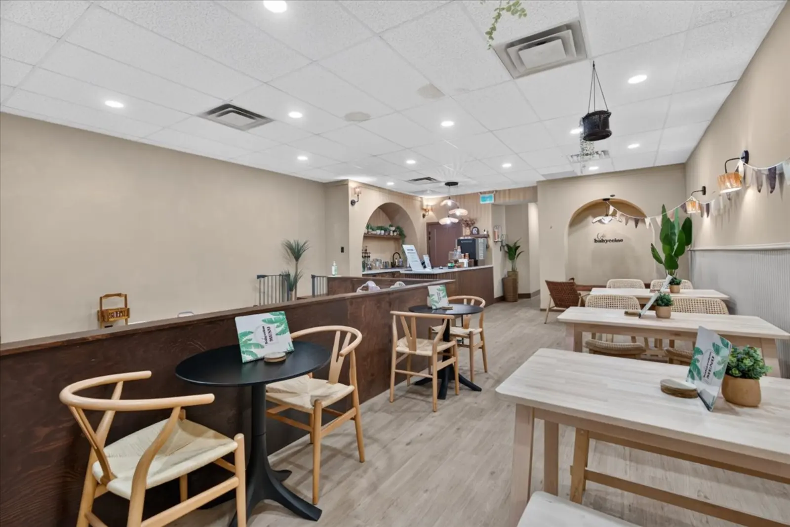 Café tables and bench seating along the wall