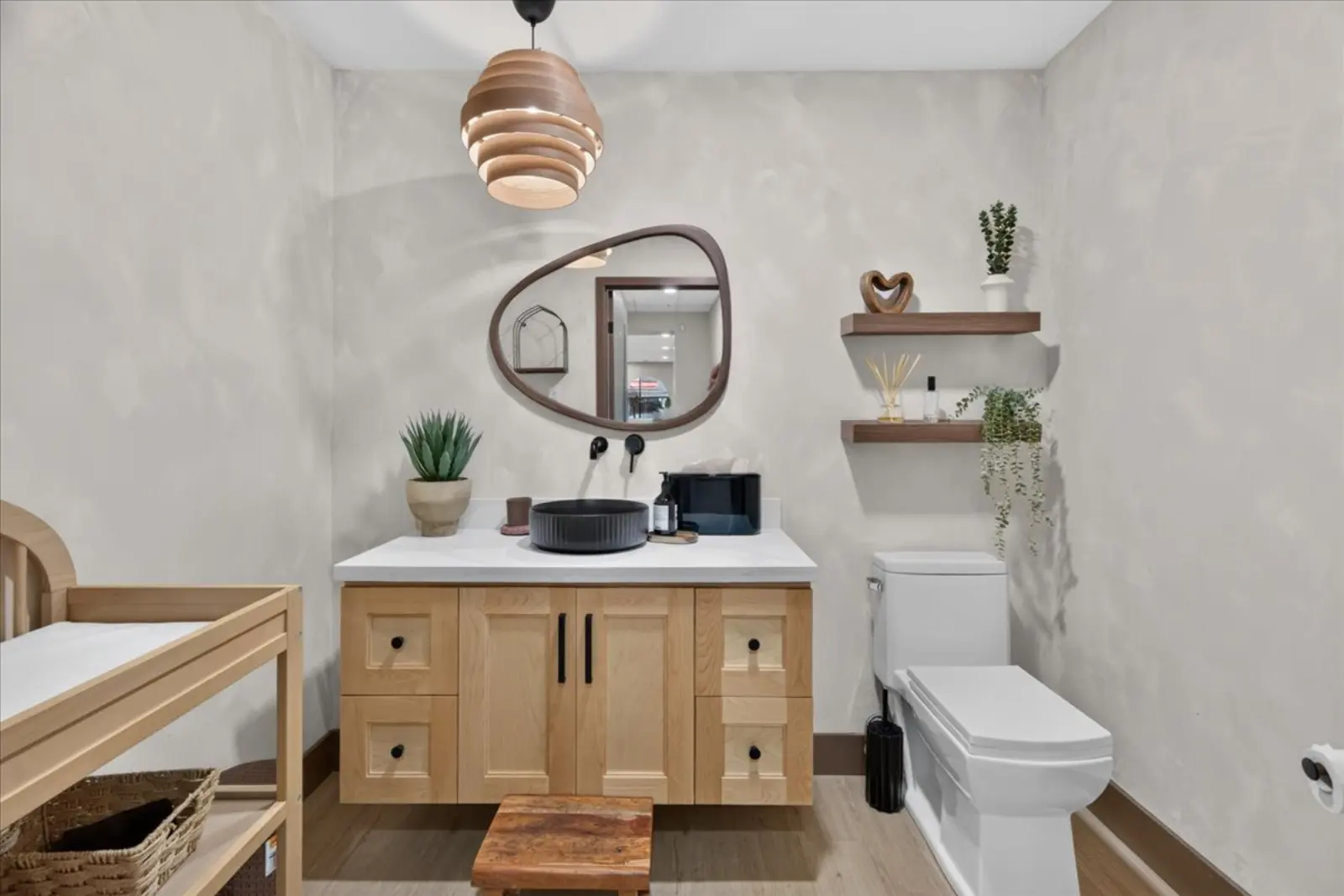 Bathroom with a wood vanity and round mirror