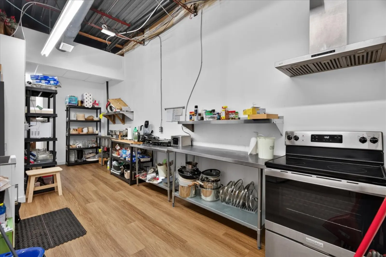 Kitchen with a range, hood and shelving