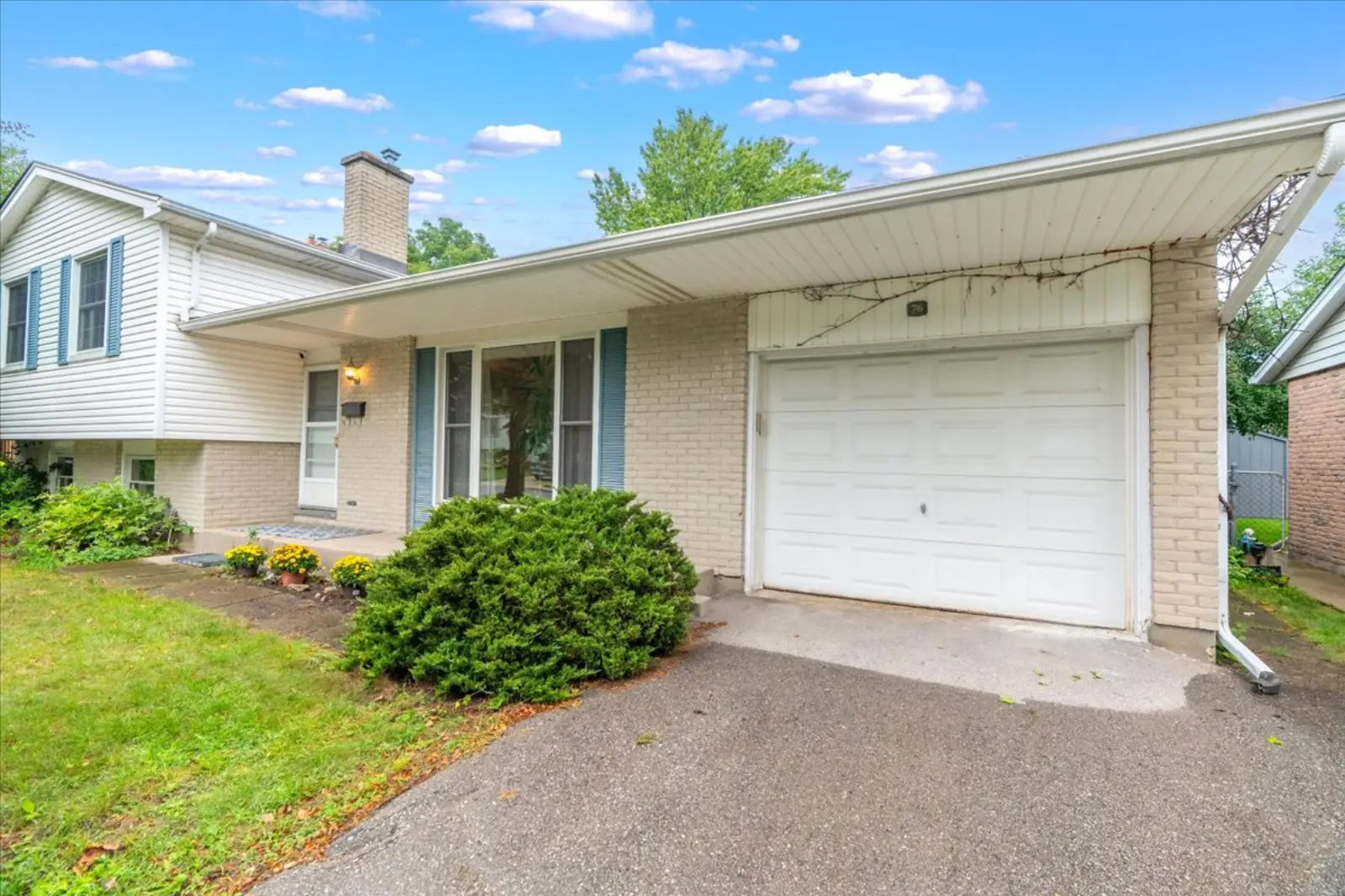 The attached garage and wide driveway